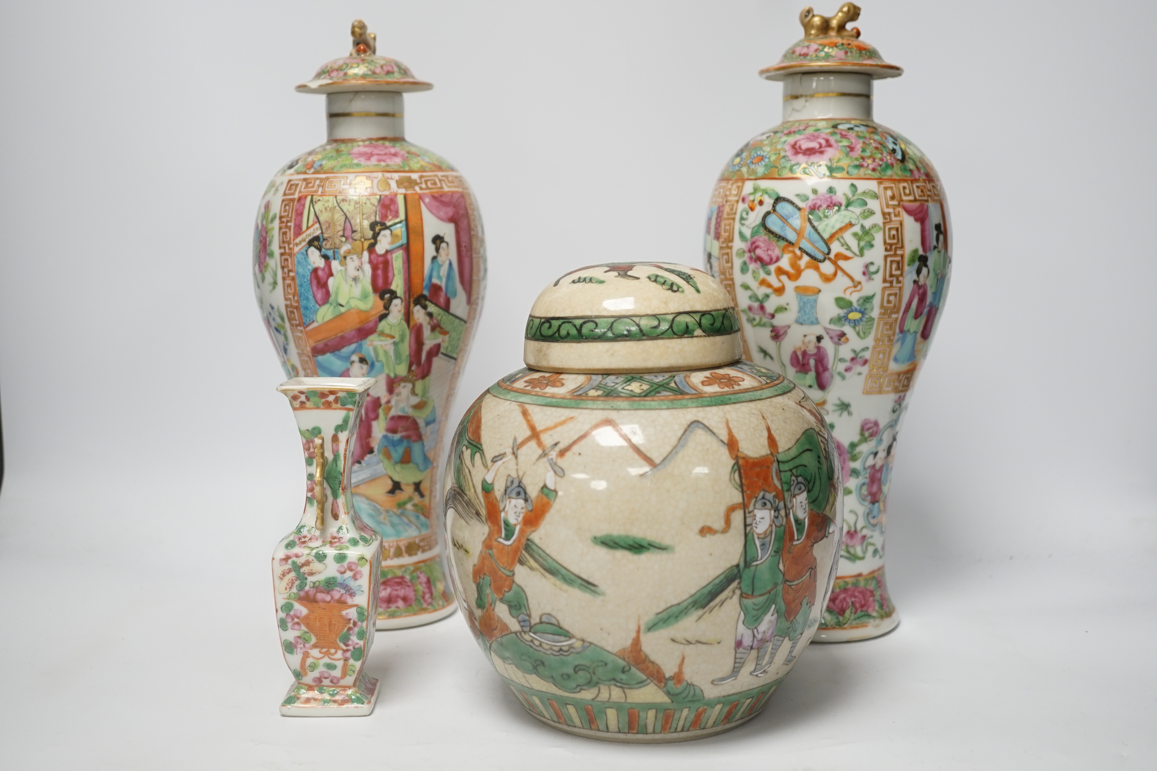 A pair of 19th century Chinese famille rose vases and covers, a similar small vase and a a famille verte crackle glaze jar, tallest 31cm